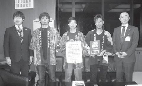 はっぴを着た団員たちと町長が並んでいる白黒の集合写真