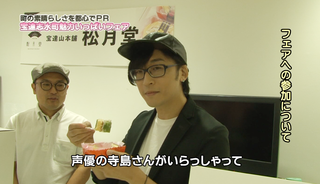 寺島拓篤さんが松月堂のロール慶次を食べながらインタビューを受けている写真